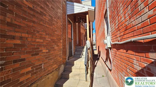 a car parked in front of a brick house