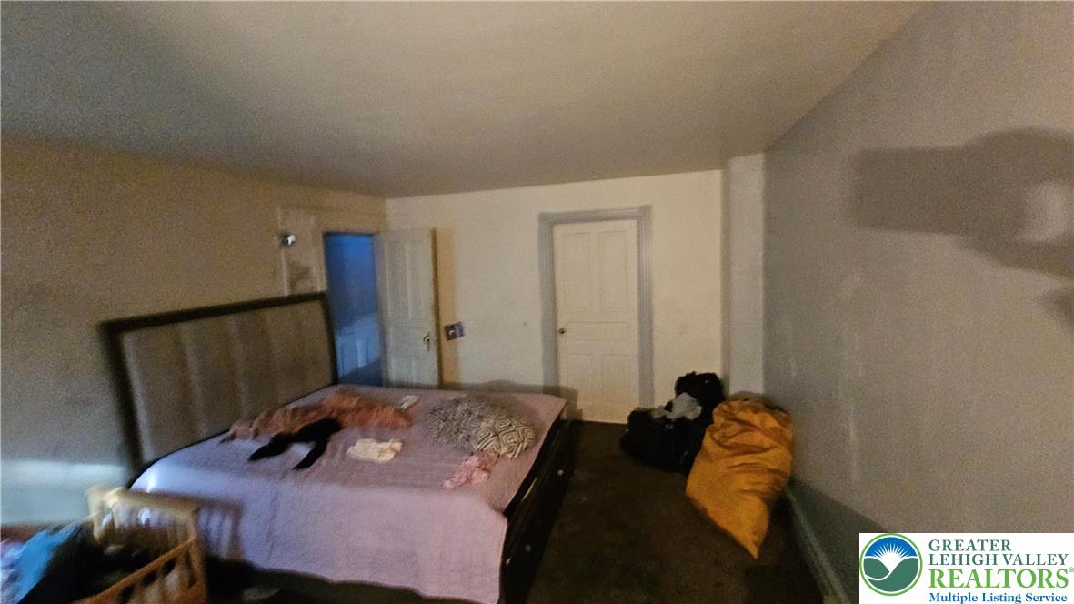 504 Tilghman Street Allentown, PA 18102 - Photo 32 of 33 a bedroom with a bed and a mirror