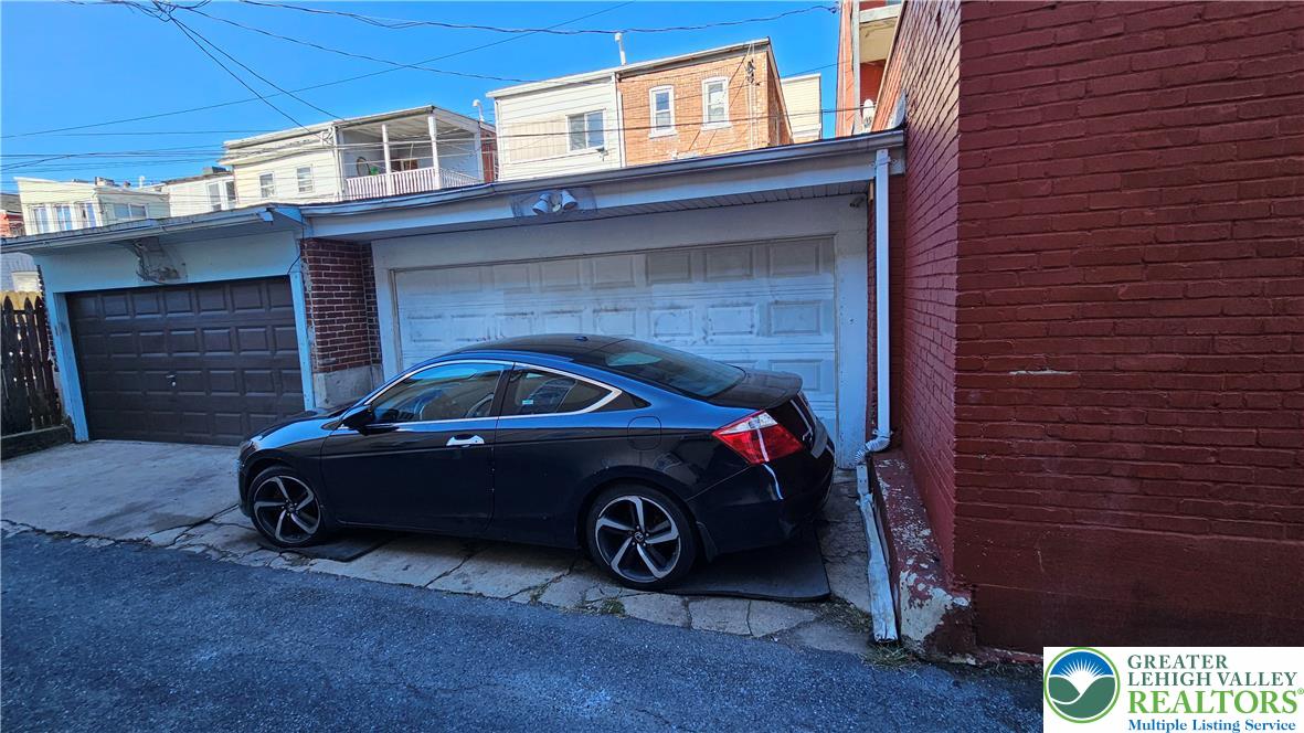 504 Tilghman Street Allentown, PA 18102 - Photo 4 of 33 a car parked in front of a brick house