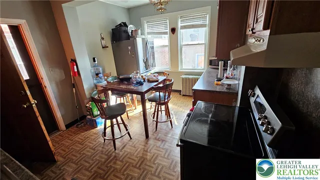 a kitchen with stainless steel appliances a sink a stove and a refrigerator