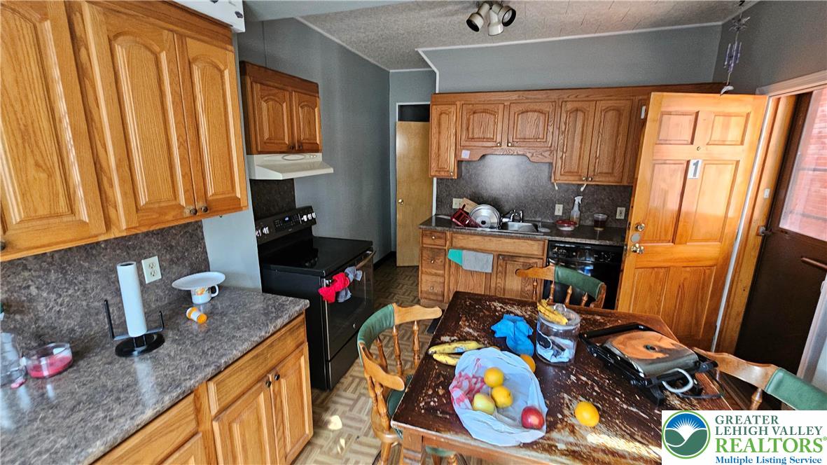 504 Tilghman Street Allentown, PA 18102 - Photo 6 of 33 a kitchen with stainless steel appliances a sink a stove and a refrigerator