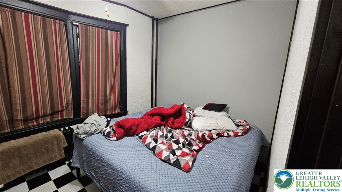 504 Tilghman Street Allentown, PA 18102 - Photo 10 of 33 a bedroom with a bed and a window