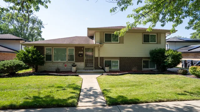 a front view of house with yard and green space