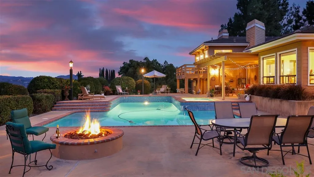a backyard of a house with table and chairs