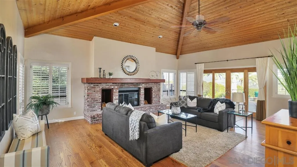 2723 Rich Lynn Ridge Road Escondido, CA 92025 - Photo 9 of 24 a living room with furniture a large window and a fireplace