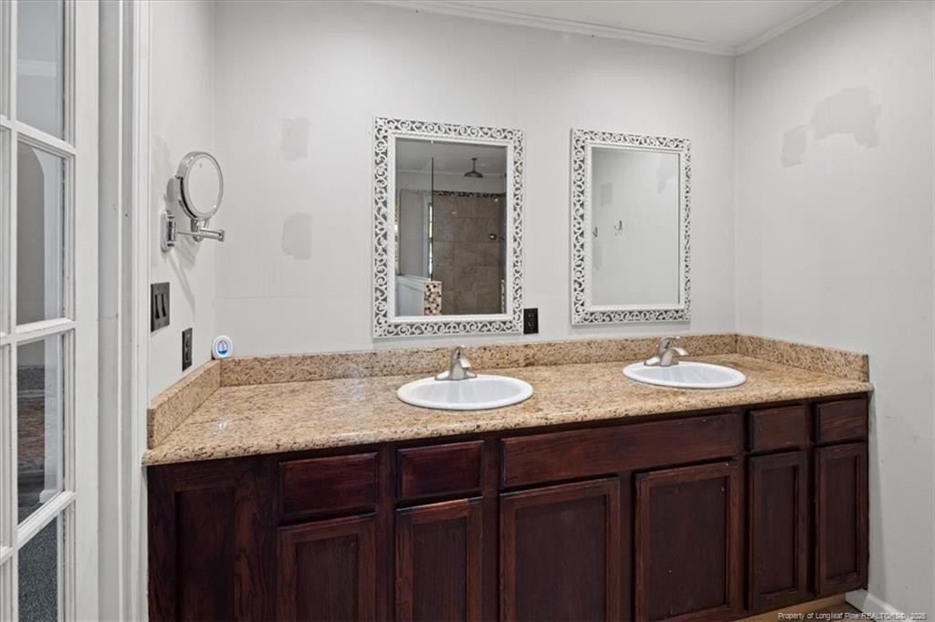 912 Main Street Raeford, NC 28376 - Photo 24 of 36 a bathroom with a granite countertop sink and a mirror