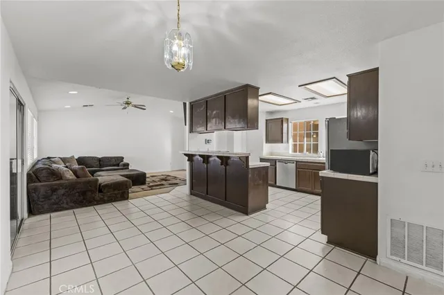 a kitchen with stainless steel appliances a stove a sink and a refrigerator