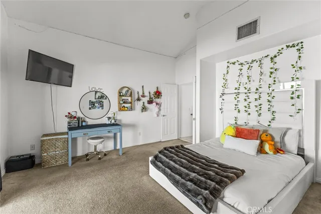 a bedroom with a bed and a dresser