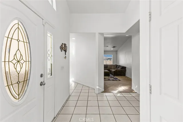a view of a livingroom with wooden floor and bathroom