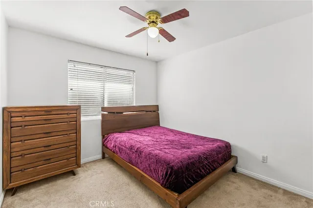 a bedroom with a bed and a view of kitchen