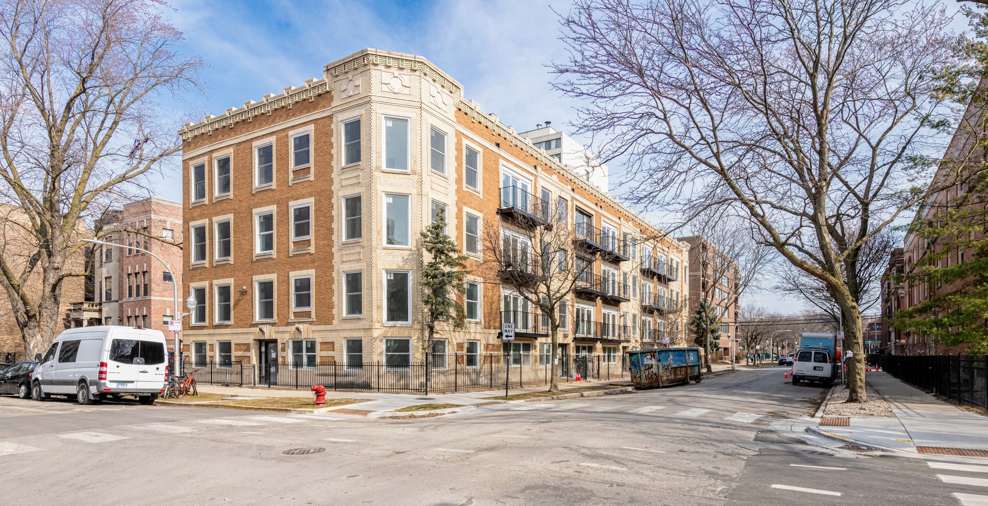 1024 West Ainslie Street, Unit 1 Chicago, IL 60640 - Photo 1 of 16 a front view of a building with lot of cars and trees