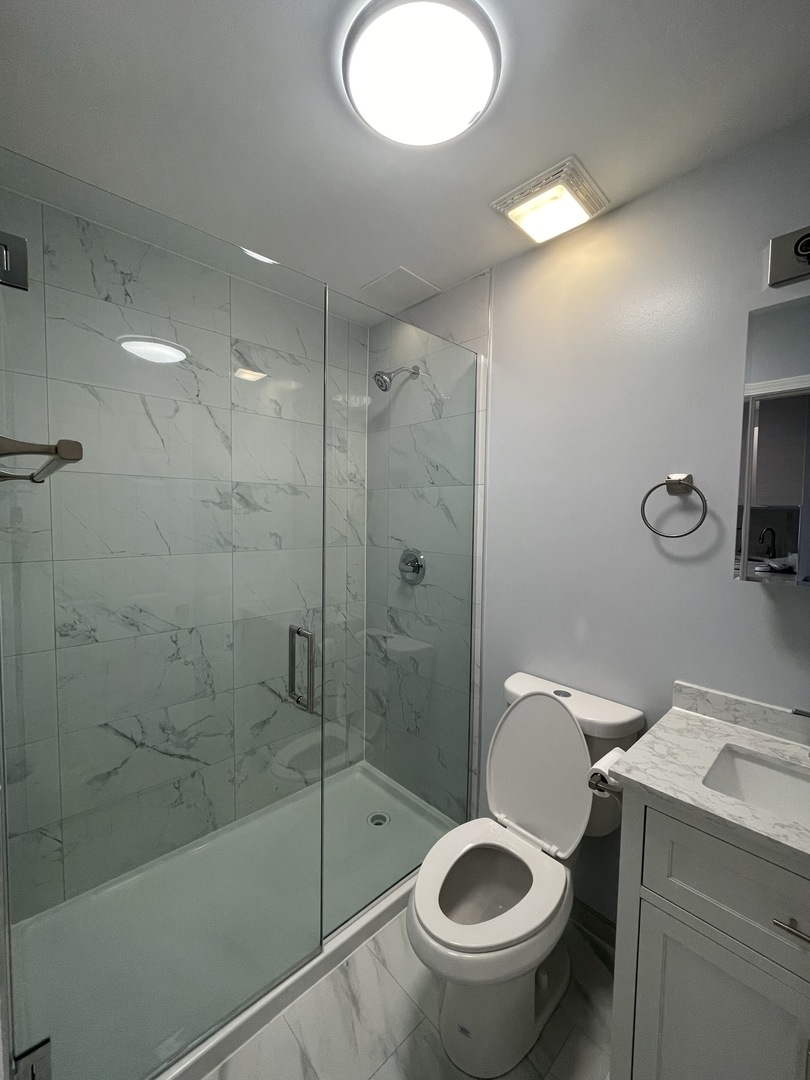 1024 West Ainslie Street, Unit 1 Chicago, IL 60640 - Photo 16 of 16 a bathroom with a toilet and a shower