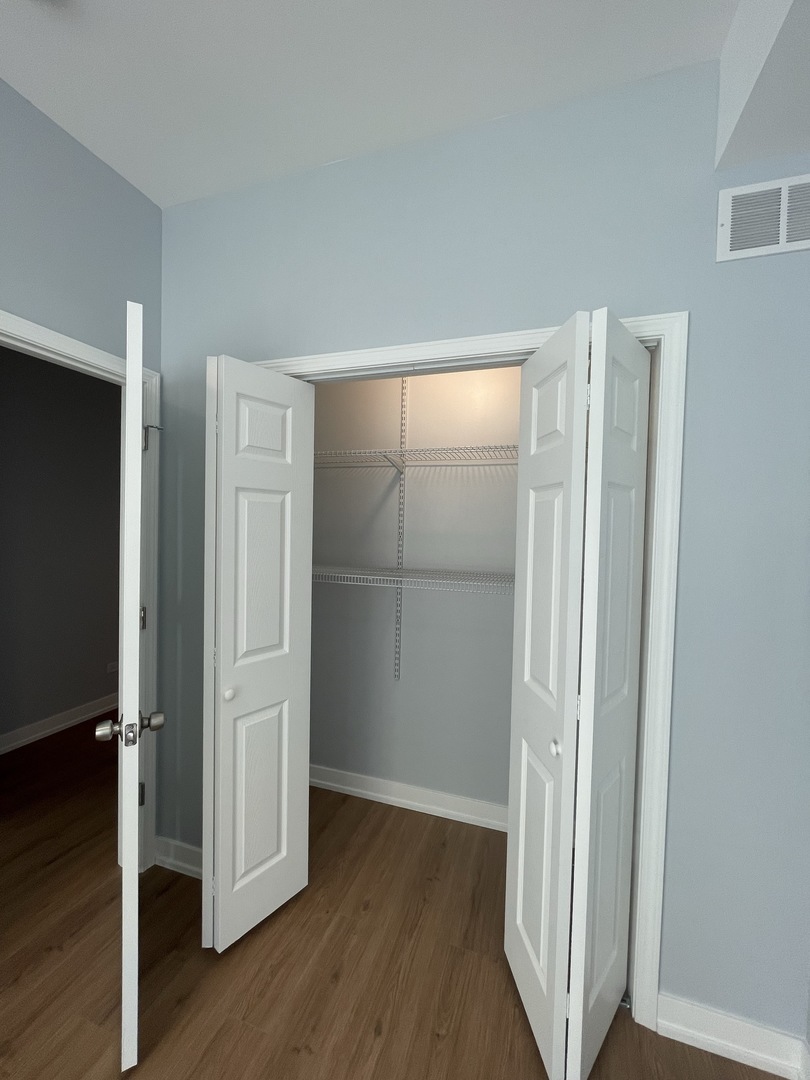 1024 West Ainslie Street, Unit 1 Chicago, IL 60640 - Photo 5 of 16 a view of front door with wooden floor