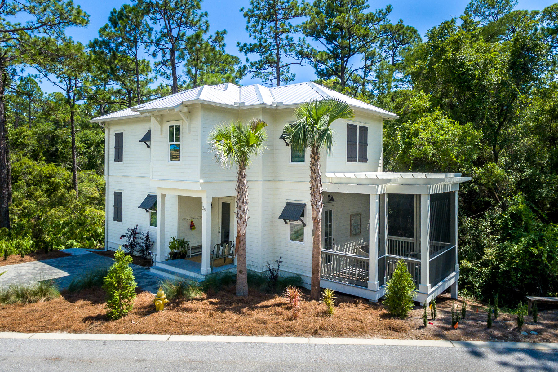 281 Redbud Ln Inlet Beach Inlet Beach, FL 32461 - Photo 1 of 34 a front view of a house with garden
