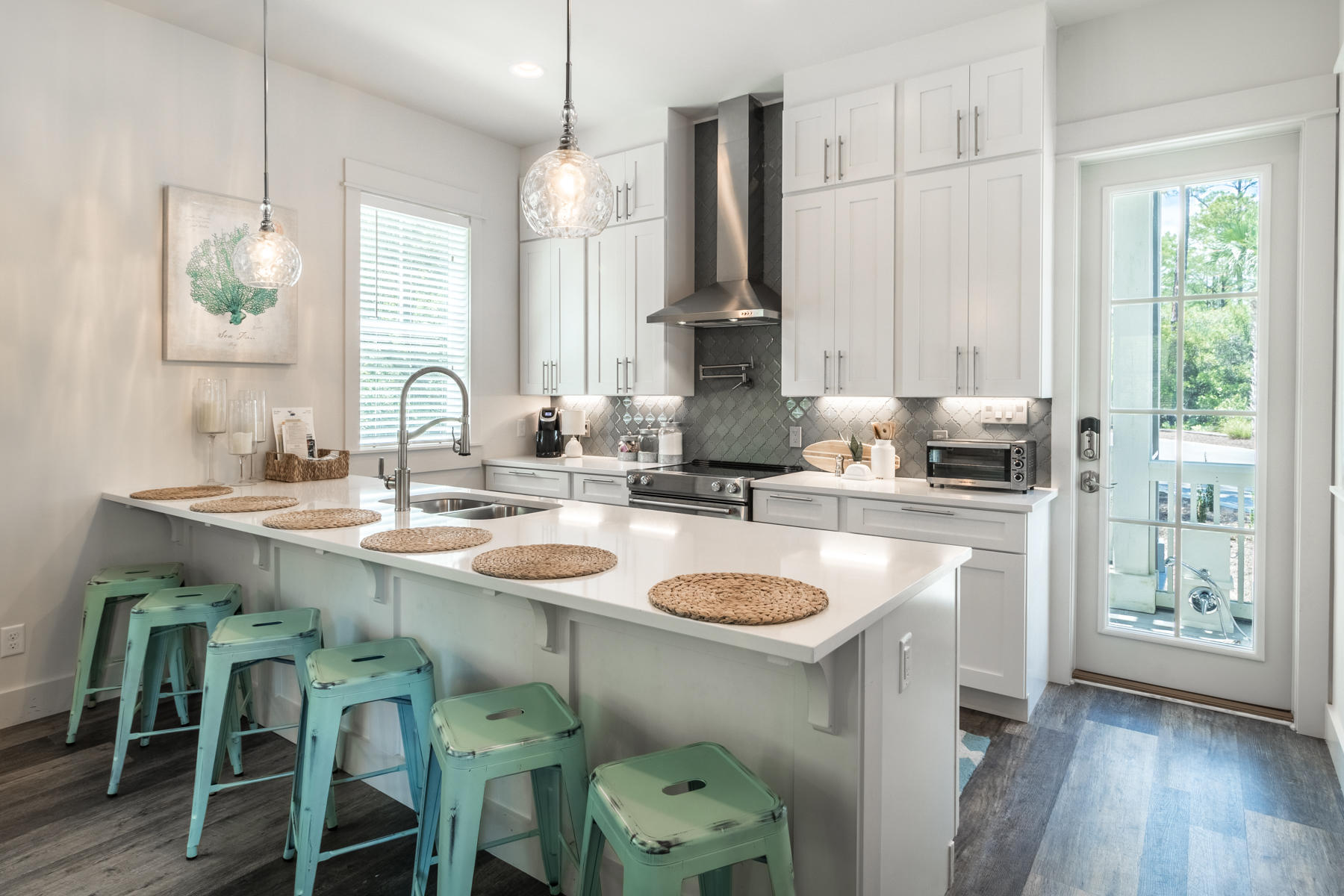 281 Redbud Ln Inlet Beach Inlet Beach, FL 32461 - Photo 2 of 34 a kitchen with a sink a stove a dining table and chairs