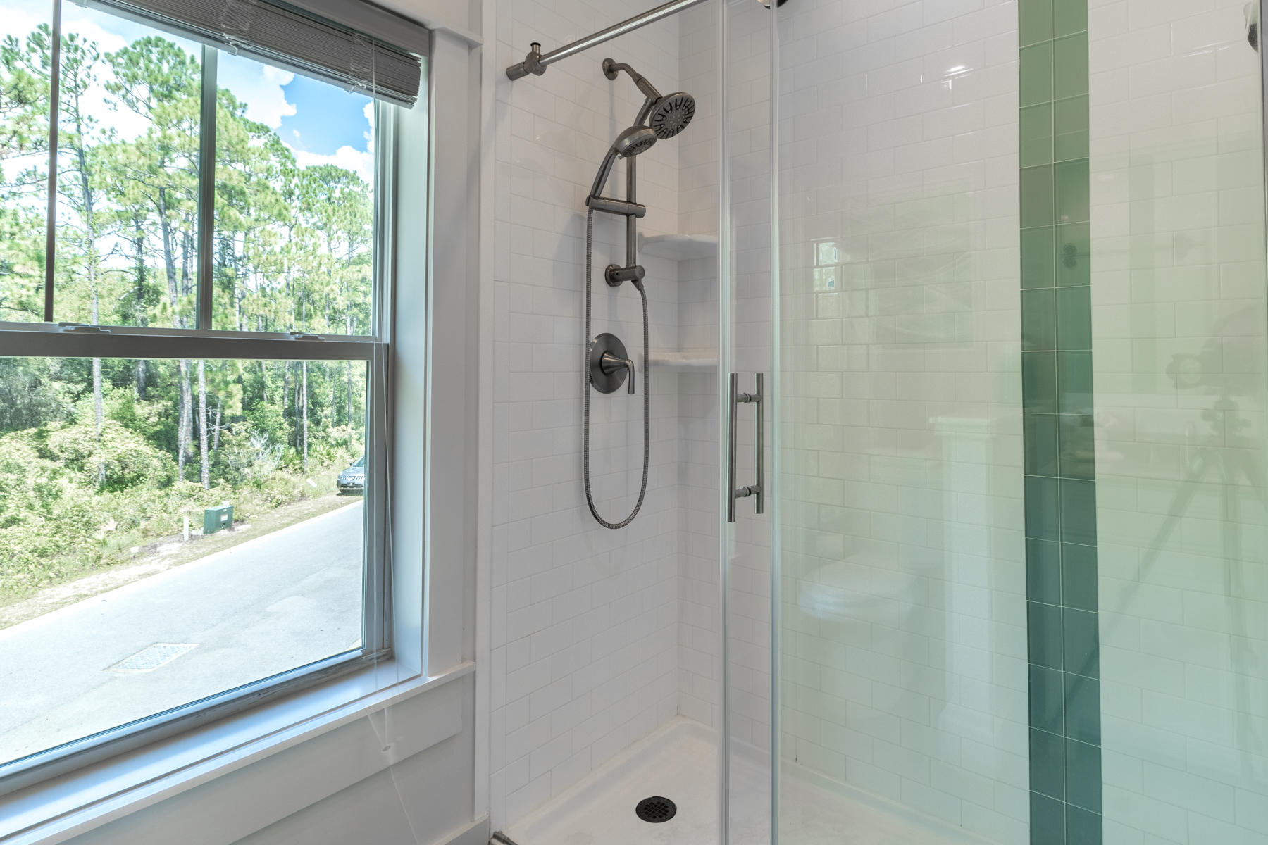 281 Redbud Ln Inlet Beach Inlet Beach, FL 32461 - Photo 22 of 34 a bathroom with a glass shower door and a window