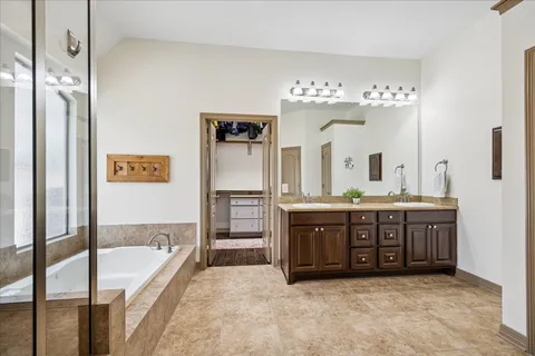 a bathroom with a granite countertop bathtub shower and a sink