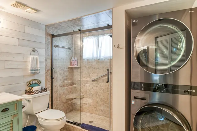 a bathroom with a sink mirror and toilet