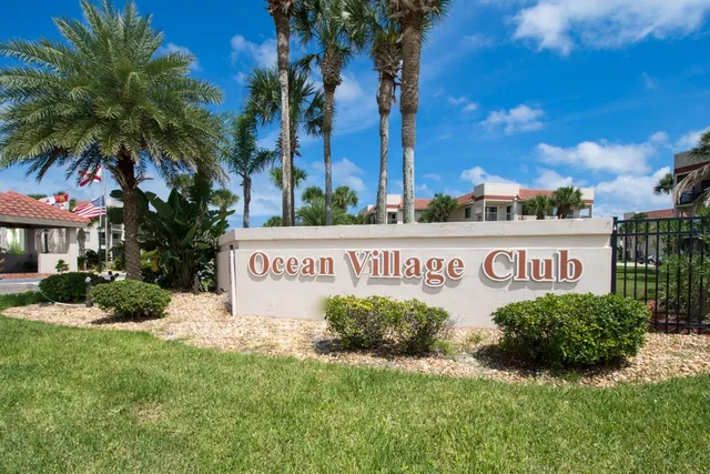 a view of a garden with a table under an umbrella