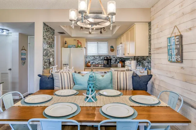 a living room with furniture and chandelier