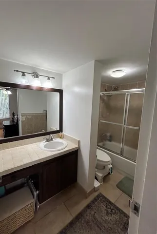 a bathroom with a sink a vanity and a mirror