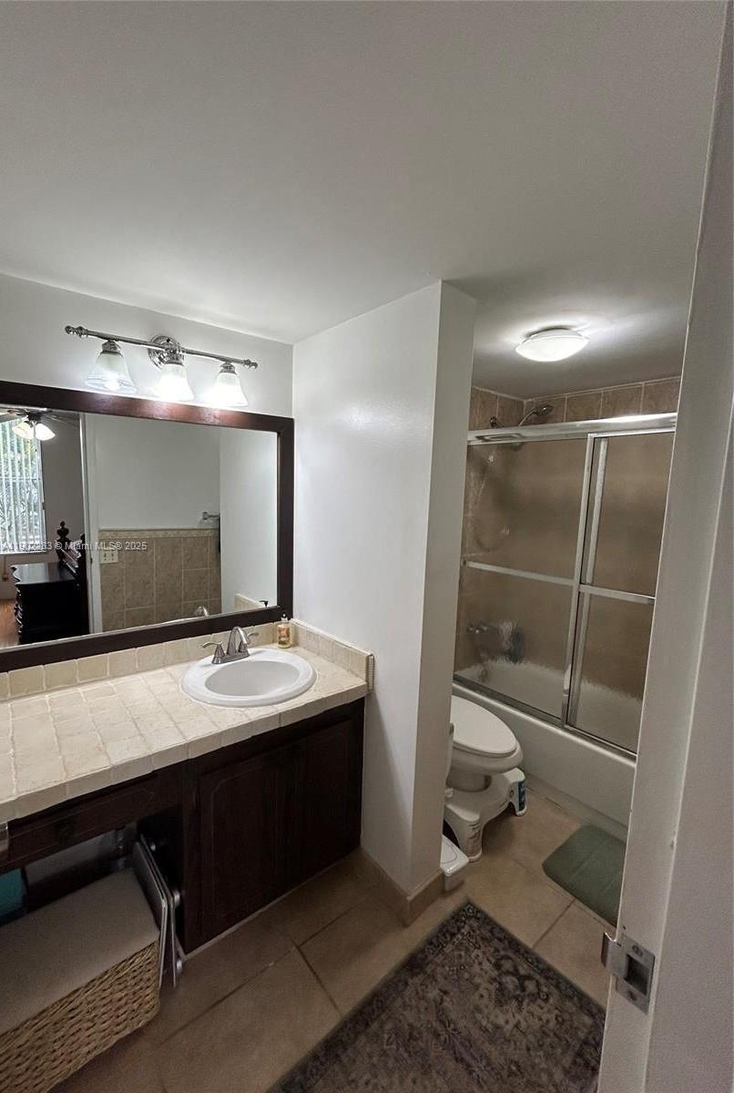 8330 Sands Point Boulevard, Unit N208 Tamarac, FL 33321 - Photo 18 of 35 a bathroom with a sink a vanity and a mirror