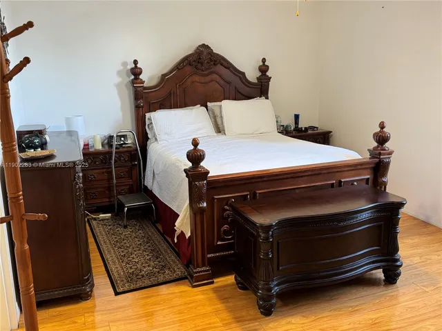 a bed sitting in a bedroom next to a window