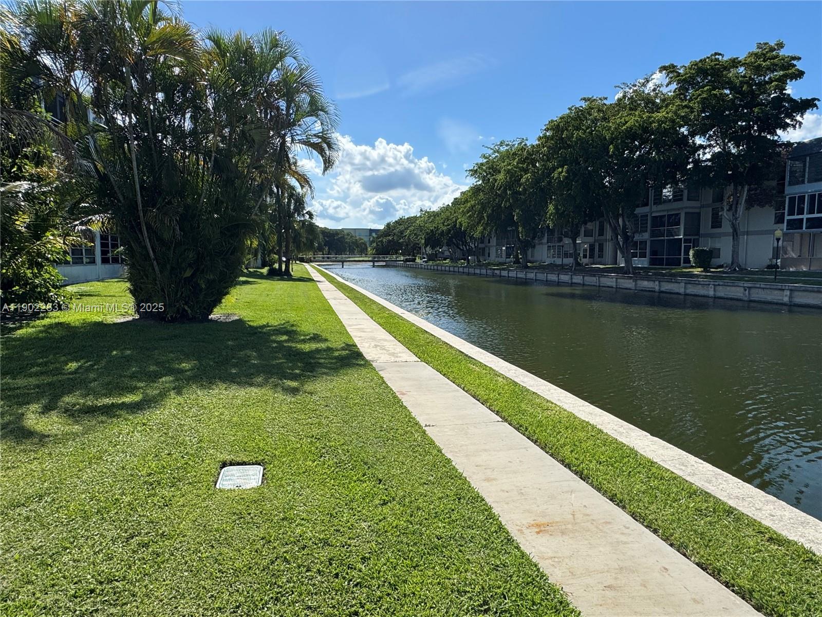 8330 Sands Point Boulevard, Unit N208 Tamarac, FL 33321 - Photo 24 of 35 a view of a lake with a yard