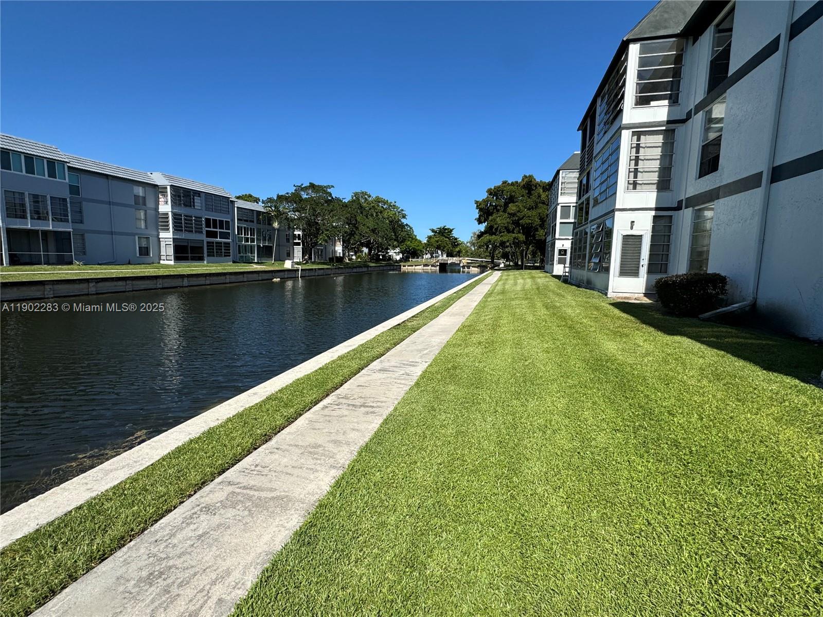 8330 Sands Point Boulevard, Unit N208 Tamarac, FL 33321 - Photo 29 of 35 a view of swimming pool with a yard