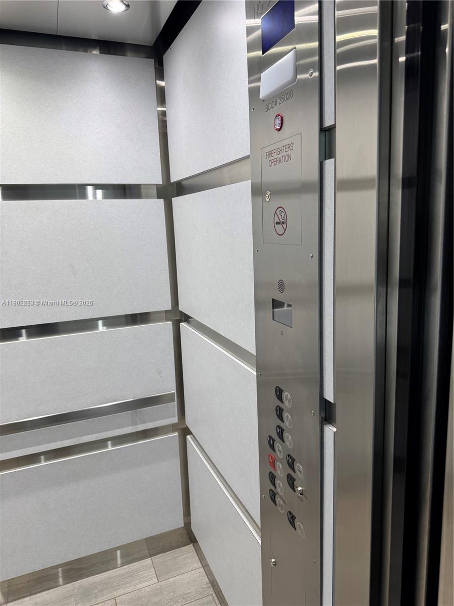 8330 Sands Point Boulevard, Unit N208 Tamarac, FL 33321 - Photo 34 of 35 a bathroom with a glass shower door