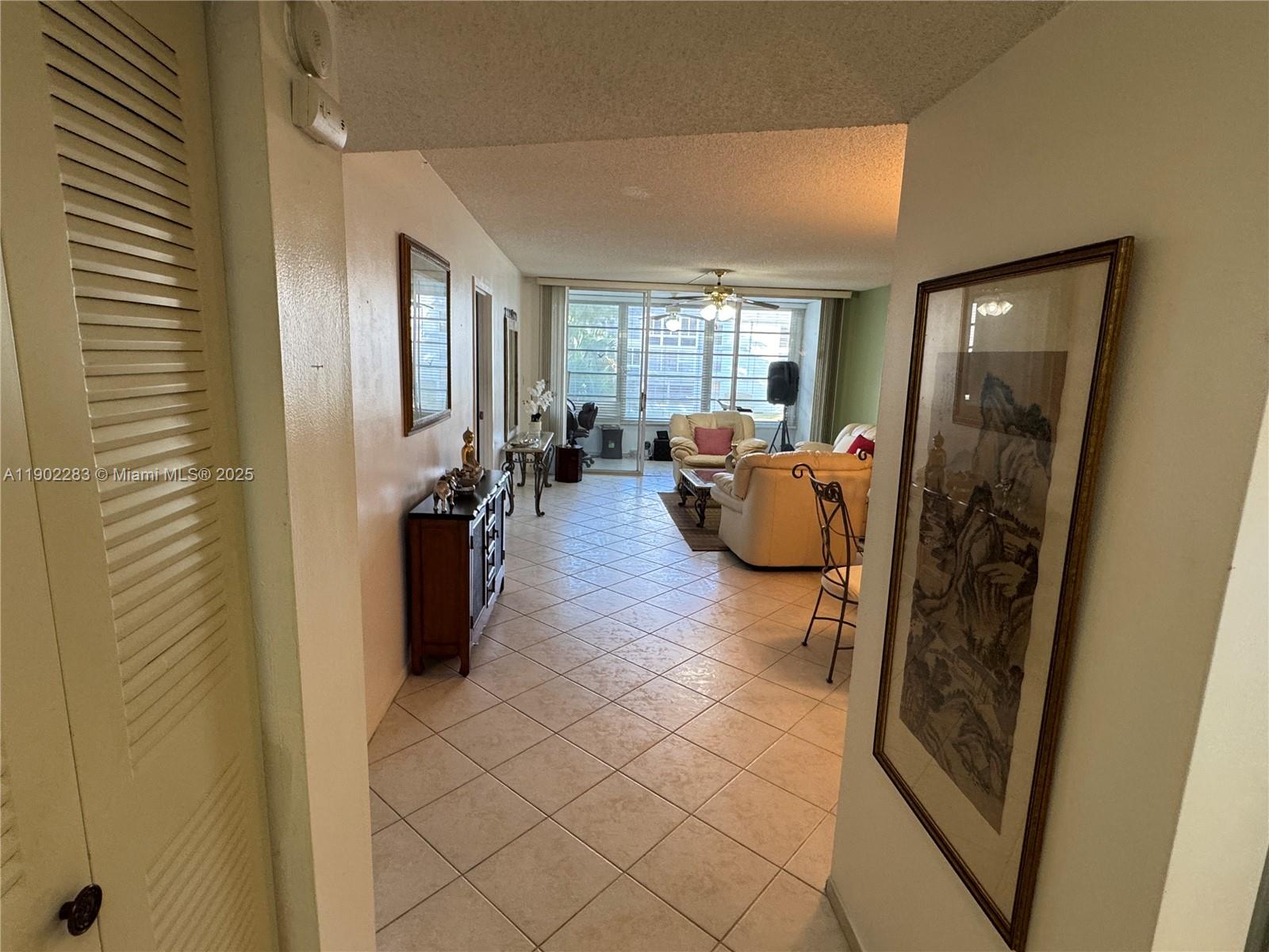 8330 Sands Point Boulevard, Unit N208 Tamarac, FL 33321 - Photo 6 of 35 a living room with furniture and a large window