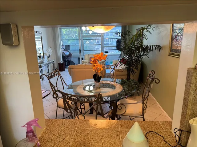 a view of a dining room with furniture and a potted plant