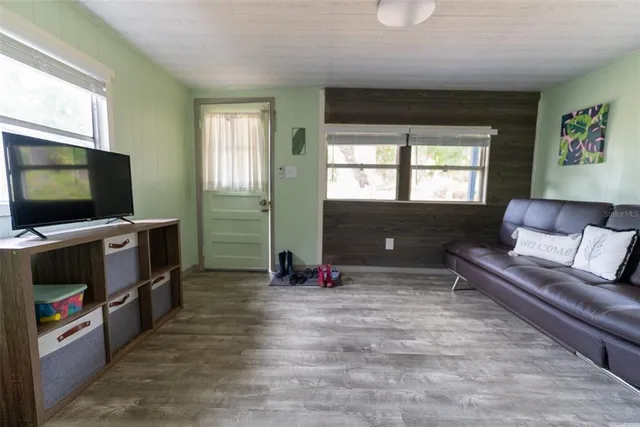 a bedroom with a bed and flat screen tv