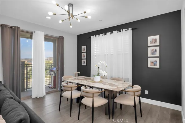 a kitchen with refrigerator a sink and chairs