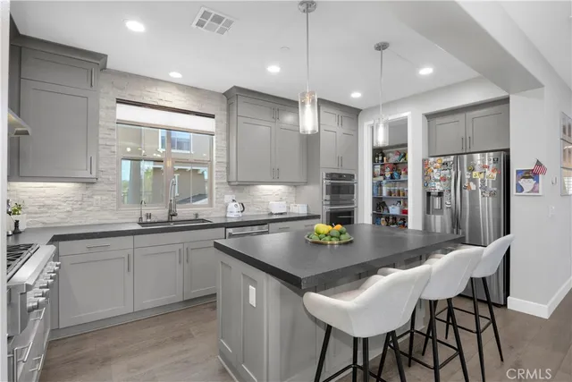 a stove top oven sitting inside of a kitchen