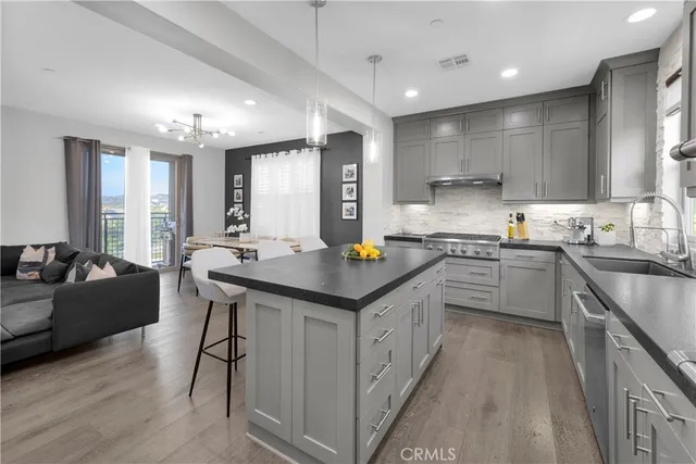 a kitchen with stainless steel appliances granite countertop a refrigerator and a sink