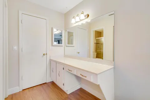 a room with a wooden floor and a window