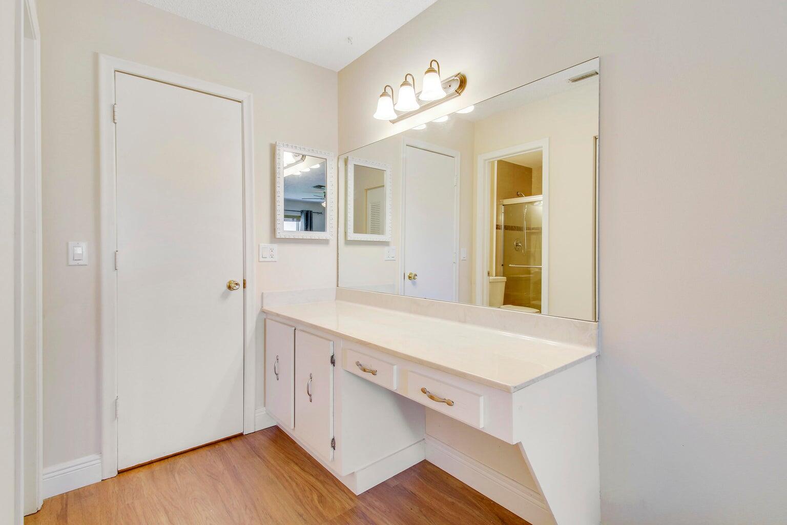 2730 Southwest 13th Street, Unit 203 Delray Beach, FL 33445 - Photo 12 of 23 a room with a wooden floor and a window