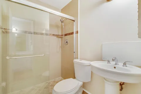 a white toilet sitting next to a bathroom sink