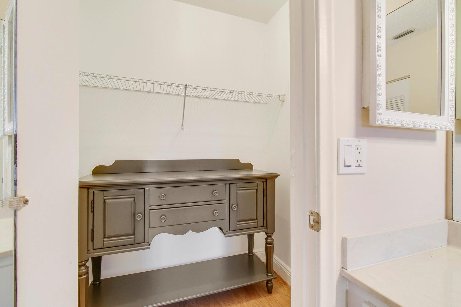 2730 Southwest 13th Street, Unit 203 Delray Beach, FL 33445 - Photo 14 of 23 a bathroom with a sink and a mirror