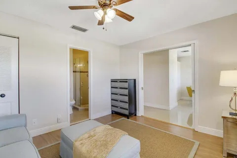 a living room with furniture and a ceiling fan
