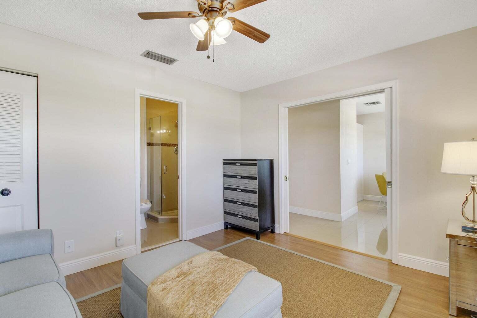 2730 Southwest 13th Street, Unit 203 Delray Beach, FL 33445 - Photo 18 of 23 a living room with furniture and a ceiling fan