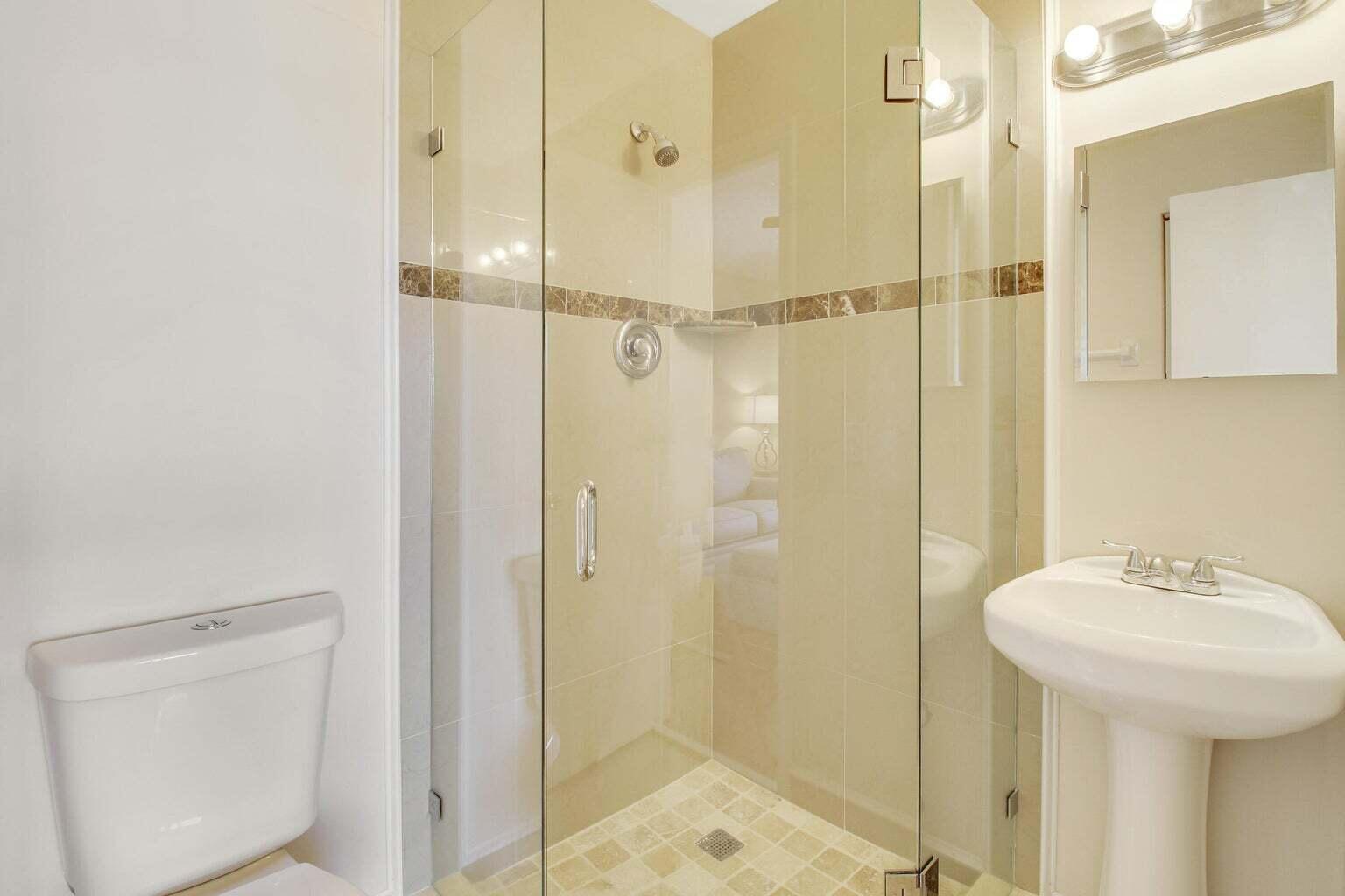 2730 Southwest 13th Street, Unit 203 Delray Beach, FL 33445 - Photo 19 of 23 a bathroom with a shower and a sink