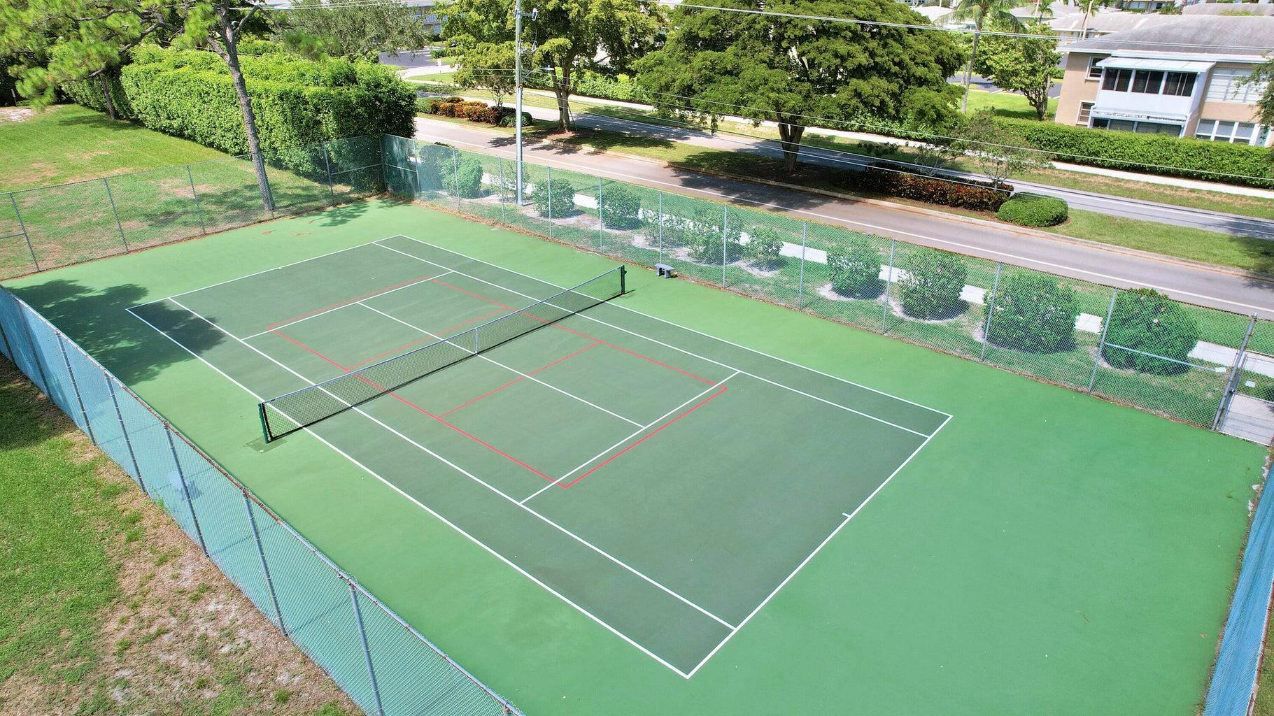 2730 Southwest 13th Street, Unit 203 Delray Beach, FL 33445 - Photo 20 of 23 a view of a tennis court