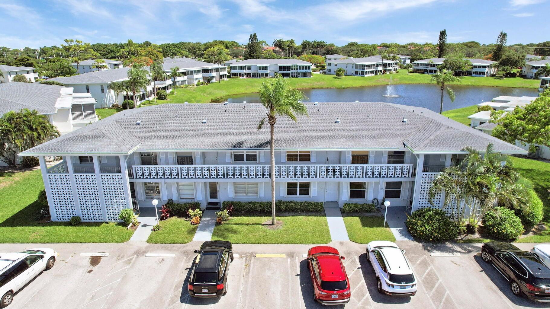 2730 Southwest 13th Street, Unit 203 Delray Beach, FL 33445 - Photo 23 of 23 a view of a house with a yard and a garden