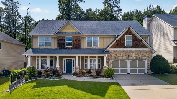 a front view of house with yard and outdoor seating
