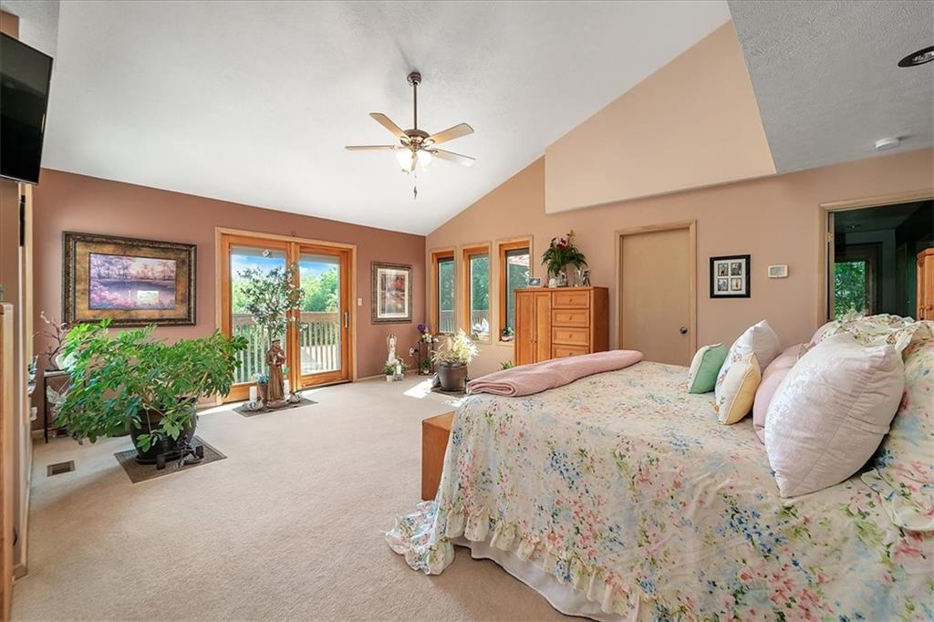 2106 Reis Run Road Pittsburgh, PA 15237 - Photo 25 of 42 a bedroom with a large bed and potted plants next to a large window