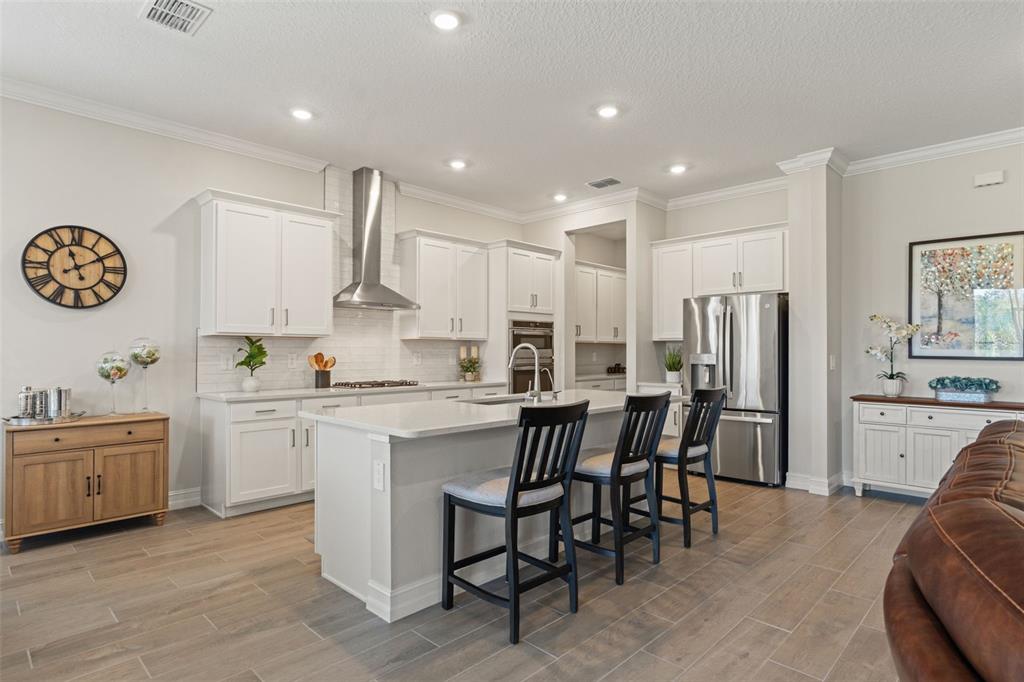 4661 Southern Valley Loop Brooksville, FL 34601 - Photo 12 of 62 a kitchen with white cabinets and stainless steel appliances