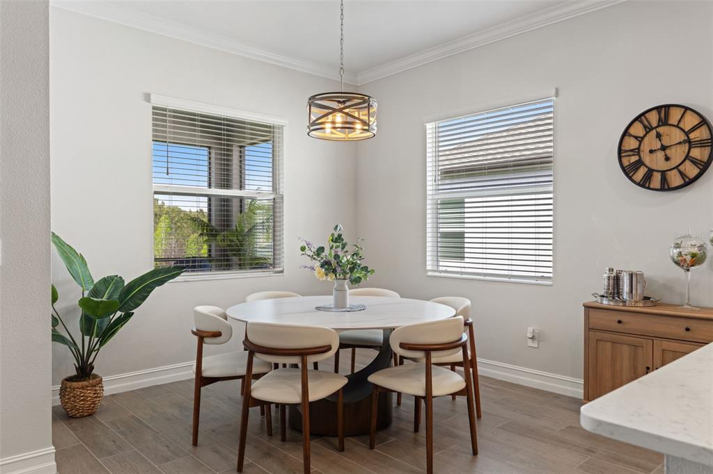 4661 Southern Valley Loop Brooksville, FL 34601 - Photo 15 of 62 a view of a dining room with furniture and a potted plant