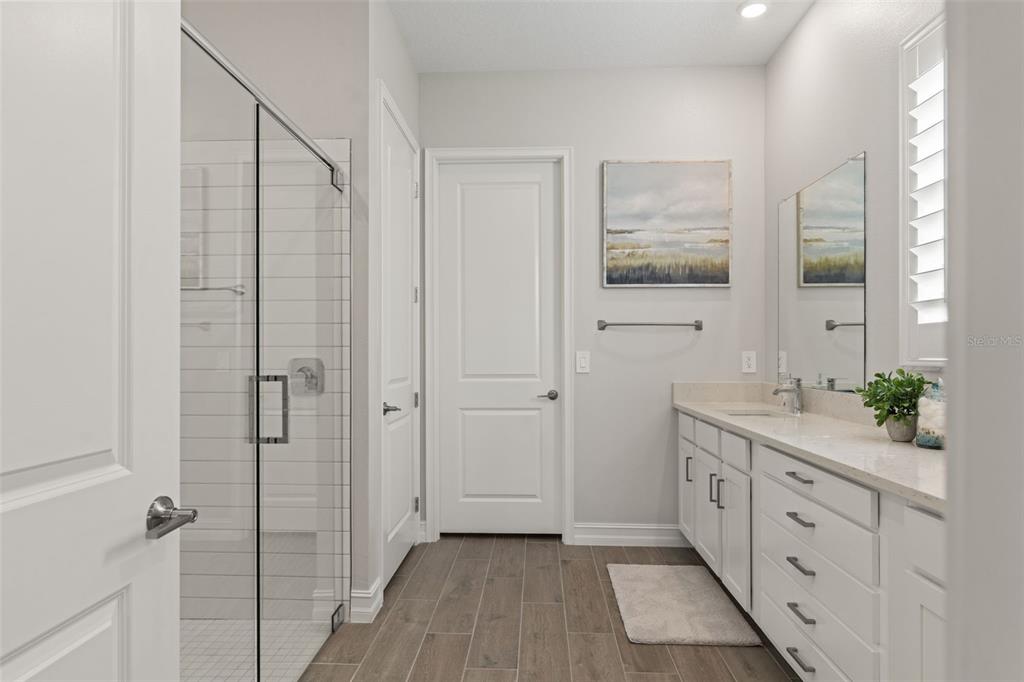 4661 Southern Valley Loop Brooksville, FL 34601 - Photo 20 of 62 a spacious bathroom with a double vanity sink and a mirror